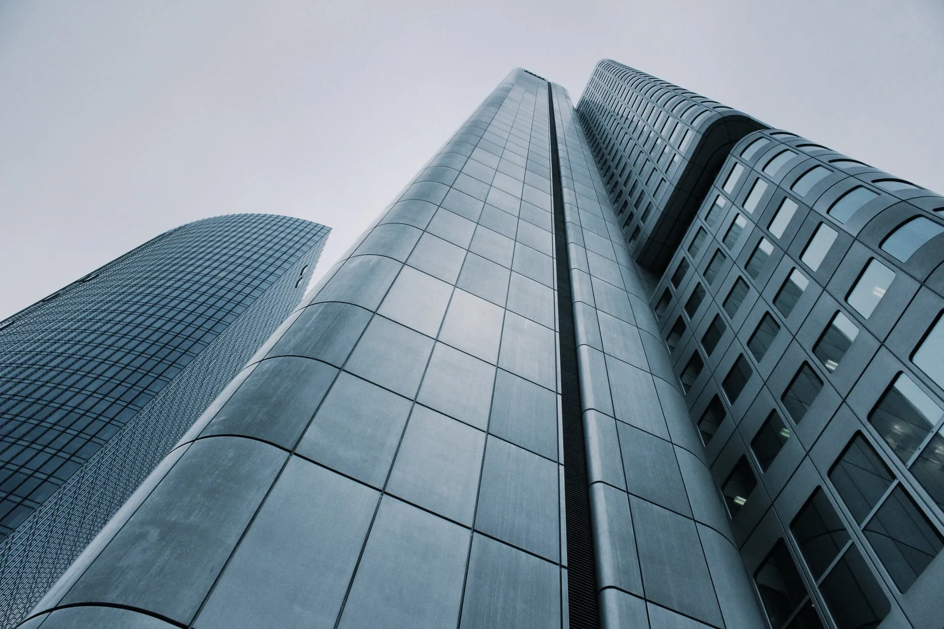 Photo looking up at tall glass buildings